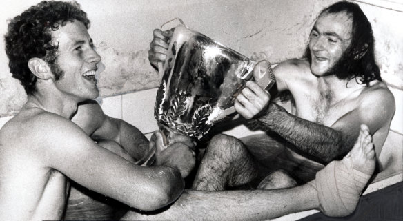 Making a splash: Robert Walls and Bruce Doull freshen up - complete with premiership cup in hand - after both had starring roles against the Tigers.