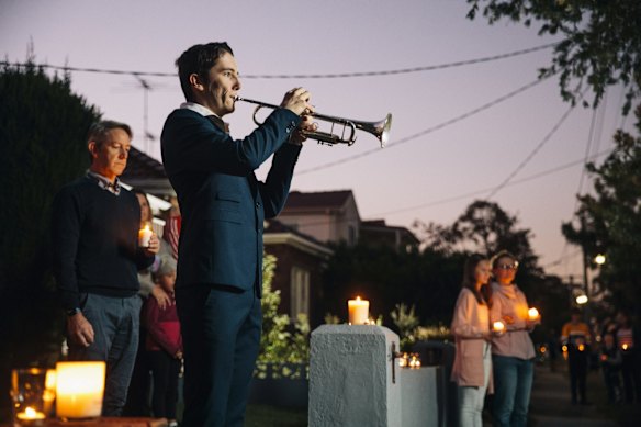 Albie Woodhouse plays The Last Post on trumpet during a driveway dawn service in Sydney to mark Anzac Day on Saturday, April 25, 2020.
