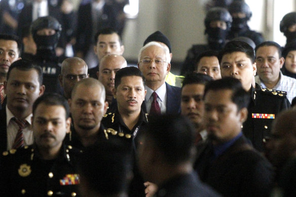 Najib Razak walks into a courtroom in Kuala Lumpur, Malaysia where he was charged with corruption offences.
