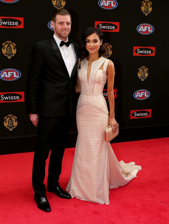Carlton footballer Sam Docherty poses for a photo with his partner Natalie Cini on the red carpet ahead of the 2015 AFL Brownlow Medal count at Crown Palladium.
