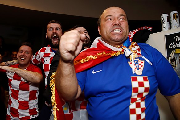 Fans celebrate after the FIFA World Cup semi-final between Croatia and England at King Tom Club in Sydney.