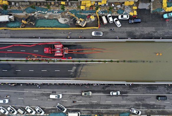 Firefighters pump rainwater from a road underpass in Zhengzhou in central China's Henan province. China's military has blasted a dam to release floodwaters threatening one of its most heavily populated provinces, as the death toll in widespread flooding rose to more than two dozens.
