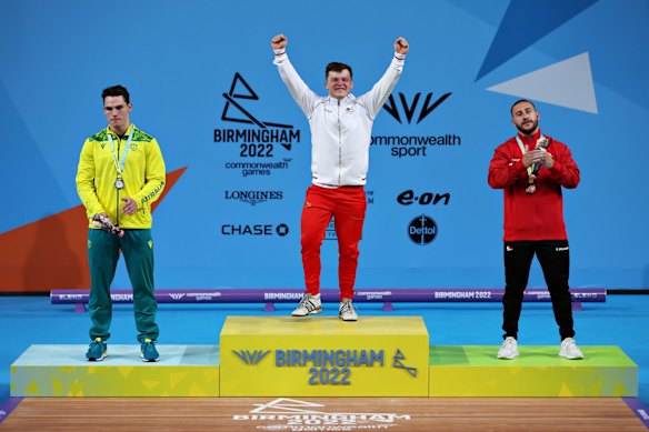 (L-R) Silver medalist Kyle Bruce of Team Australia, gold medalist Christopher Murray of Team England and bronze medalist Nicolas Vachon of Team Canada take part in the medal ceremony for Men's 81kg Final.