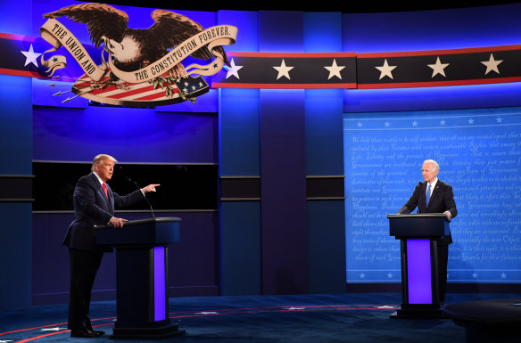 Donald Trump speaks as Joe Biden listens during the final presidential debate at Belmont University in Nashville, Tennessee.