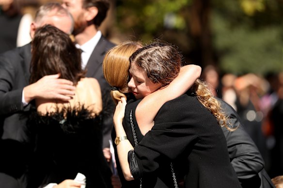 Bianca Spender is comforted outside St. Mary's cathedral.
