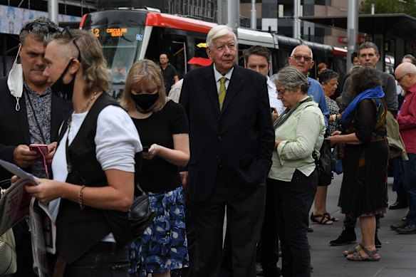 People wait to head into Sydney Town Hall.