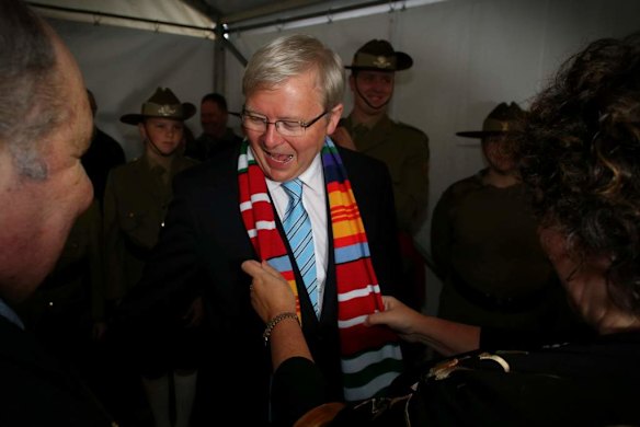 Therese Rein wife of Prime Minister Kevin Rudd places a Vietnam Veteran campaign colours scarf around his neck at a gunfire breakfast in Adelaide.