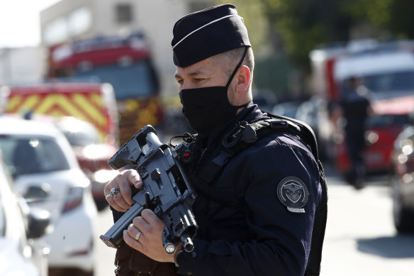Police officer guards the police station in Rambouillet where the attack took place. 