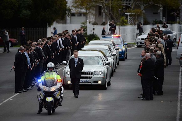 Funeral of Chris Lane at Saint Thereses Parish Church in Essendon , a guard of homour for Chris as the casket leaves the church