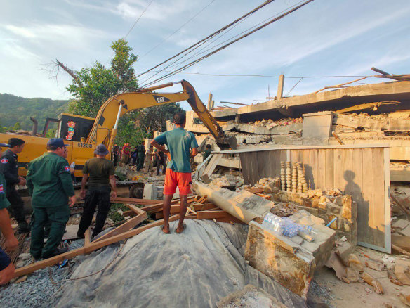 Heavy machinery removes debris after a building collapsed in Kep province.