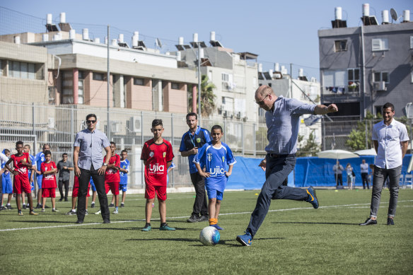 Prince William plays soccer with Jewish and Arab children.