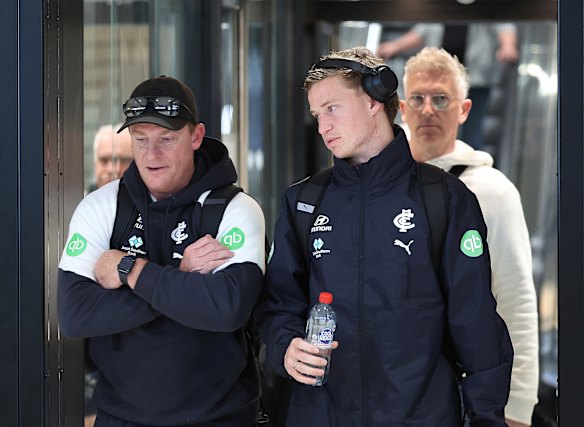 Time to step up: Carlton coach Michael Voss and player Flynn Young at Melbourne Airport on Friday.
