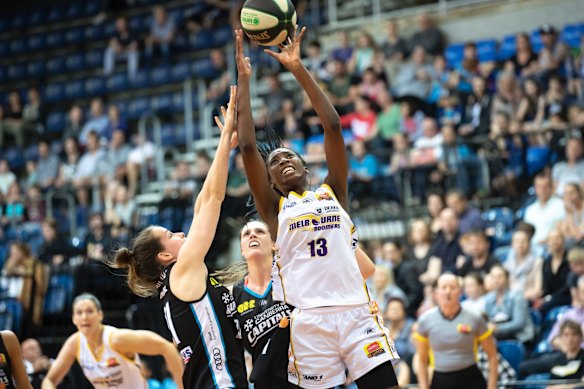 Boomers' Ezi Magbegor tries to get through Capitals' Keely Froling and Lauren Scherf. 