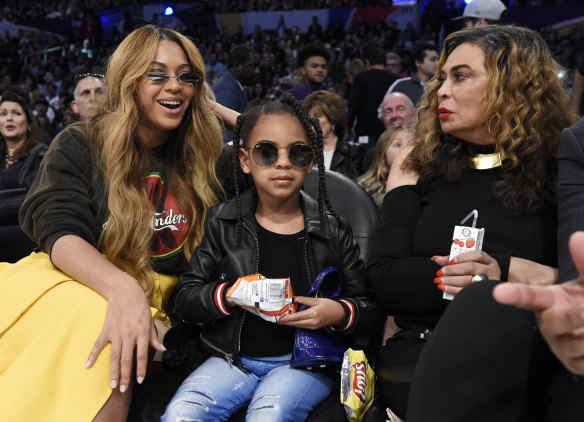 Tiny girl, grand tastes ... Blue Ivy (centre) at the basketball with her mother, Beyonce (left), and grandmother, Tina Knowles. 