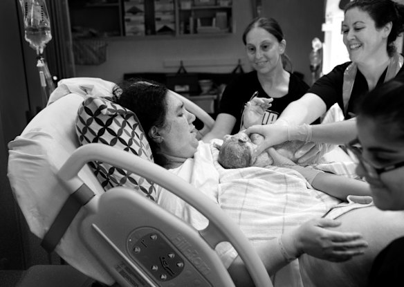 Same sex couple Rachelle Keenan (birth mum) and Fabiana Perfilio, centre, were told the waiting time for donor sperm in Australia was two years so they decided to do IVF with donor sperm from The USA. This is the moment baby Charlie was placed on Rachelle after being born, by midwife, Natalie Parker, right, at the Liverpool Hospital, in Western Sydney. (Other midwife in foreground is Nicole Serrao.)