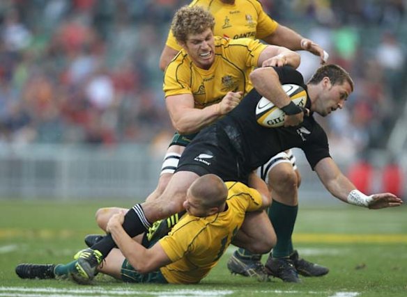 Cory Jane is tackled by Drew Mitchell and David Pocock.