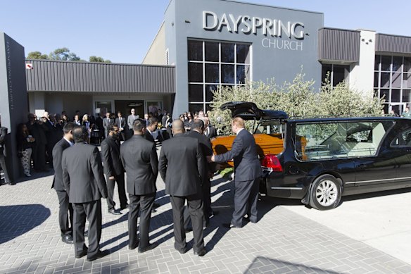 The coffin of Myruan Sukumaran is taken from the hearse at Day Spring Church, Castle Hill.