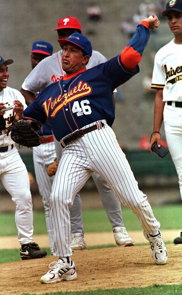 In this Feb. 25, 1999 file photo, Venezuela's President Hugo Chavez, wearing the national baseball team uniform, pitches to Chicago Cubs out fielder Sammy Sosa during a batting exhibition at Universtity Stadium in Caracas, Venezuela.