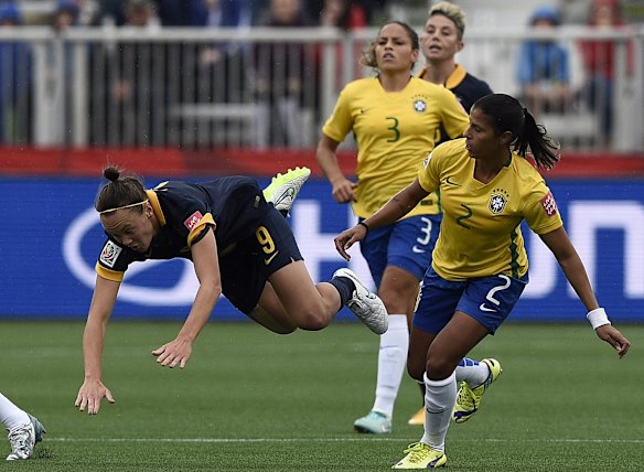 Australia's forward Caitlin Foord (L) is tackled by Brazil's defender Fabiana.