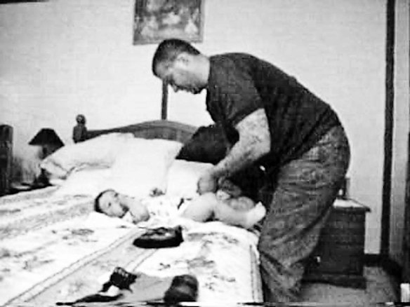 Mark "Chopper" Read changing his son's nappy.