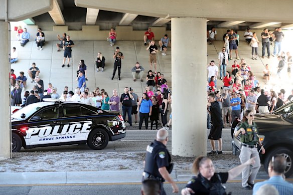 Waiting for word from students parents and family gather at Coral Springs Drive and the Sawgrass Expressway.