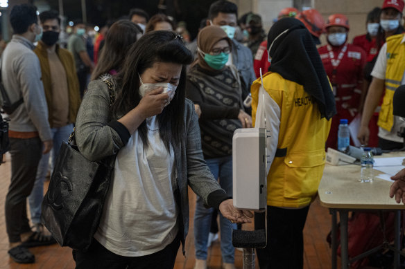 A woman whose relative was on the plane breaks down in tears. 