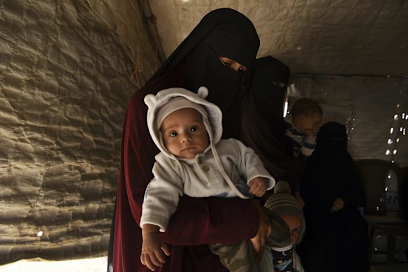Kirsty Rosse-Emile, 25 (2nd from left), holding her 2 month old son Yahya (left), the youngest Australian baby in Al-Hawl camp in North East Syria. There are 20 Australian women and 46 Australian children detained in Al-Hawl camp for their association with Islamic State fighters. 