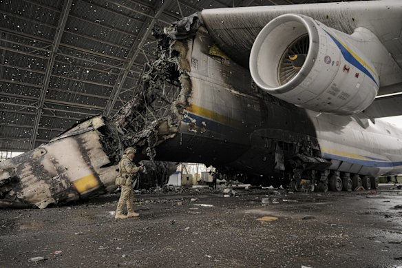 A Ukrainian soldier walks by the remains of the world's largest plane, Ukraine's Antonov An-225 Mriya, destroyed by retreating Russian forces at the Antonov airport in Hostomel. The loss of the aircraft has generating alarm and sadness among the aviation world, in which it occupies almost cult status. 