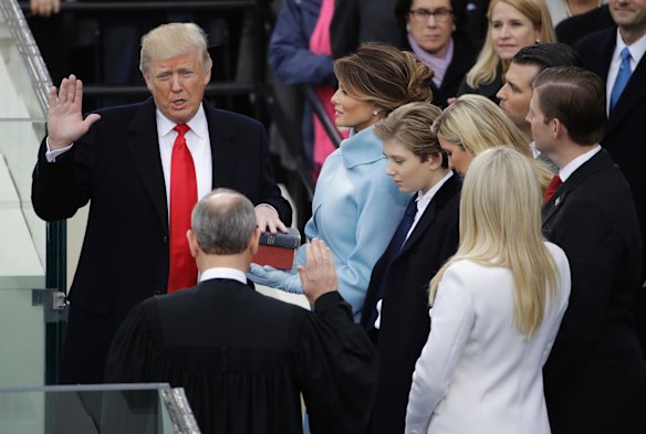 Donald Trump is sworn in as the 45th president of the United States by Chief Justice John Roberts as Melania Trump looks on during the 58th Presidential Inauguration at the U.S. Capitol in Washington, Friday, Jan. 20, 2017. (AP Photo/Matt Rourke)