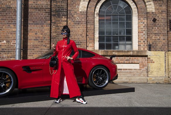 Millie Sykes wearing all vintage clothes and carrying a Poppy Lissiman bag. 