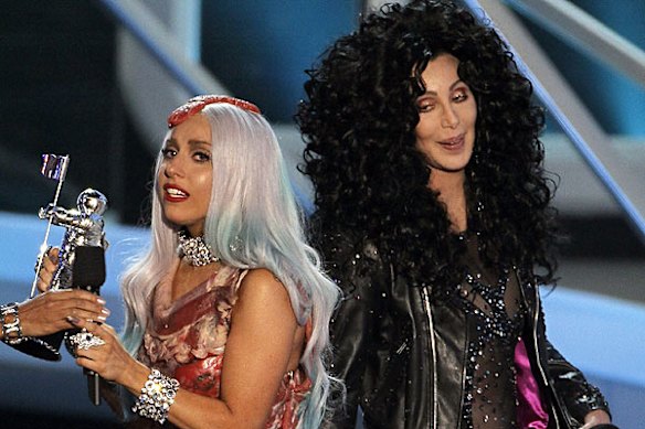 Lady Gaga accepts an award from the original diva, Cher.