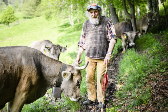 Farmer Armin Capaul on a meadow with his cows in Perrefitte near Moutier in the canton of Berne, Switzerland,.