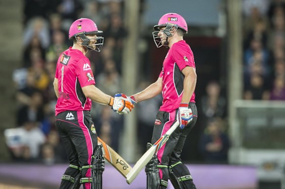 Ryan Carters of the Sydney Sixersand Moises Henriques of the Sydney Sixersbring up their 50.