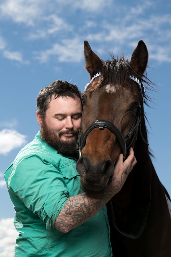Retired serviceman Clayton Hellyer, who suffers from PTSD, interacts with Vashka, a retired racing horse, as part of a equine therapy program run by Racing NSW in Capertee, NSW.