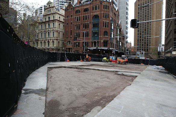 Workers prepare the road surface as progress continues on the Sydney Light Rail on the corner of Bridge and George St.