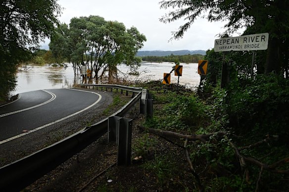 The road towards the Yarramundi Bridge leads into the swollen Nepean River.