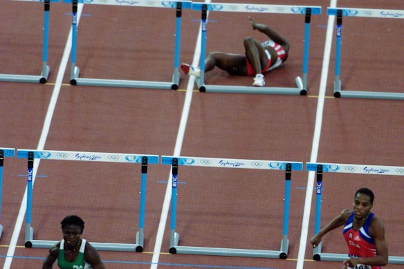 Katie Anderson of Canada falls during the second round of the women's 100m hurdles.
