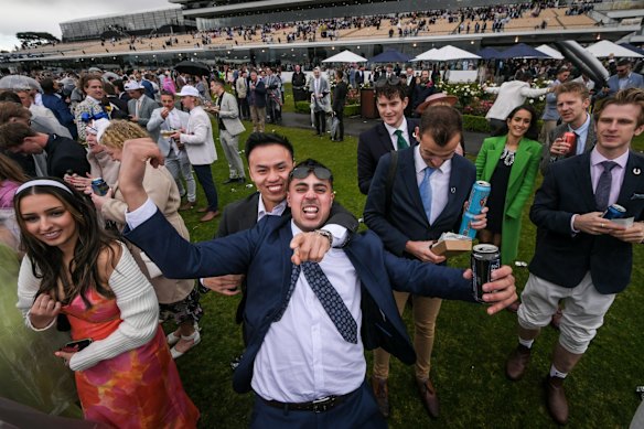 Two punters celebrate a win in race six.