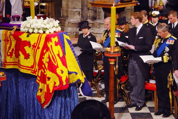(L-R) Queen Elizabeth II, Prince Philip, Prince William, Prince Andrew,  Princess Anne, Prince Charles and Peter Phillips stand in front of the Queen Mother’s coffin on April 9, 2002.