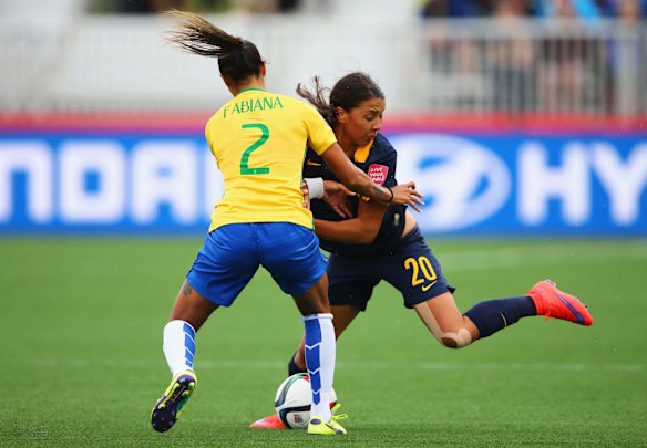 Samantha Kerr of Australia and Fabiana of Brazil battle for the ball.