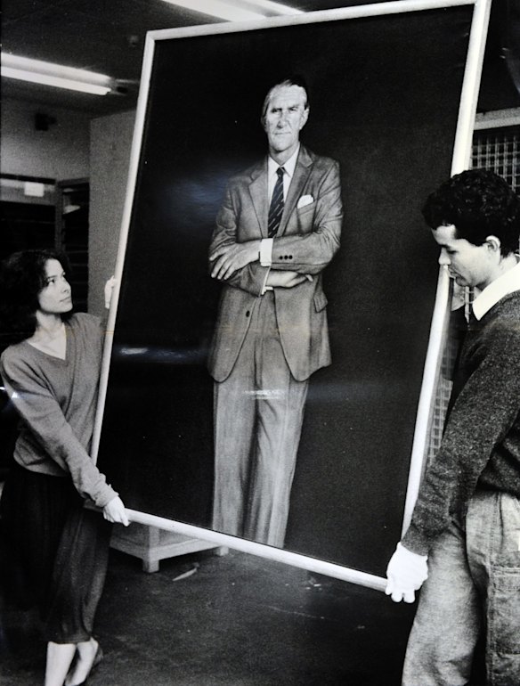 A portrait of Former Prime Minister Malcolm Fraser by Bryan Westwood being moved by National Gallery staffers Sara Kelly and Tim Fisher. (6/5/85)