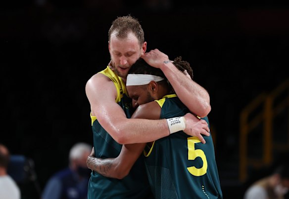 Joe Ingles #7 of Team Australia hugs teammate Patty Mills #5 after their win over Team Slovenia in the Men's Basketball Bronze medal game on day fifteen of the Tokyo 2020 Olympic Games at Saitama Super Arena on August 07, 2021 in Saitama, Japan.