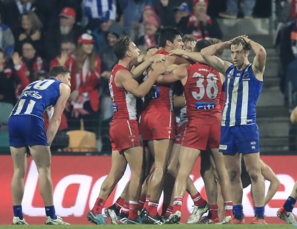 Upset: The Swans celebrate their unexpected victory over North Melbourne.