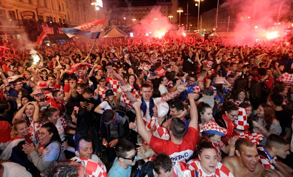 Croatian fans celebrate at the end of the semifinal match between Croatia and England, in Zagreb, Croatia.