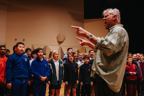 Choir master Stuart Davis teaching the song Follow Your Dreams.