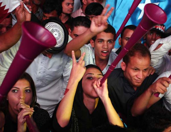 Youths celebrate in Doha after Qatar was chosen to host the 2022 World Cup.