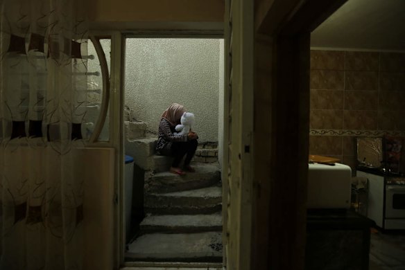 A female internally displaced person (IDP) hugs a teddy bear given to her by her now husband, the one precious possession she has from home when fleeing from ISIS in Fallujah to Baghdad, Iraq. This woman lived in Fallujah when the Islamic State, also known as ISIS, took over Fallujah. She still has relatives in Fallujah which is still under ISIS control. Baghda, Iraq.