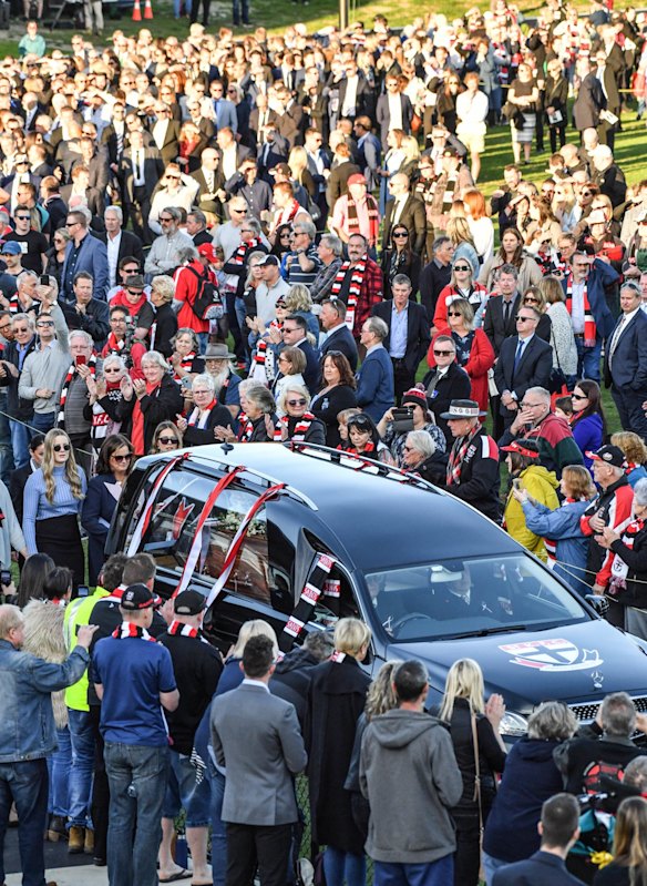 The hearse makes final lap of honour of Moorabbin oval followed by Danny's wife and daughters.