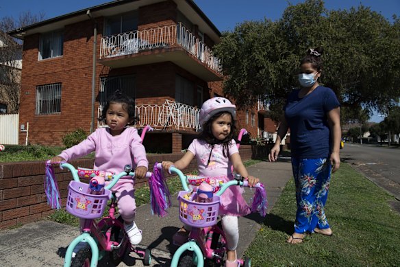 Baibhav Shah holding her daughter Aabhaya, on the balcony of their apartment in Campsie.