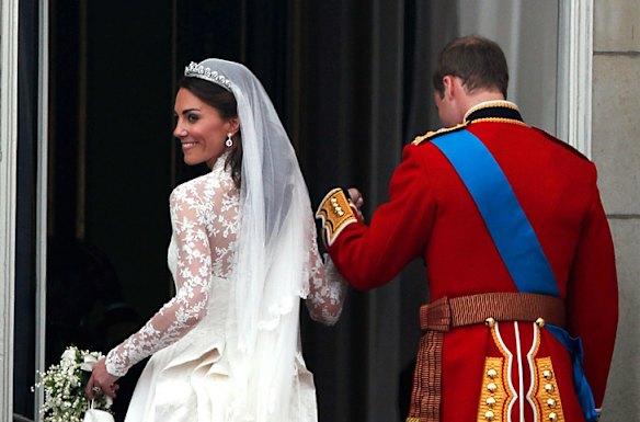 Catherine, Duchess of Cambridge looks back as Prince William, Duke of Cambridge takes her from the balcony at Buckingham Palace.